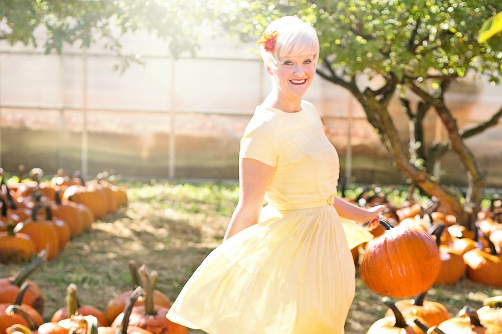smiling woman in pumpkin patch