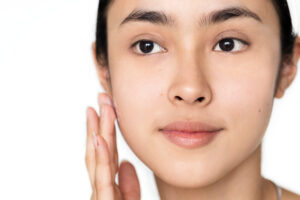 Best age for laser skin treatments. Portrait of a woman doing her daily skincare routine.